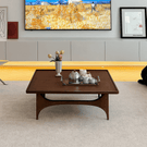 Modern square wooden coffee table with open frame base front view in living room