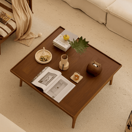 Modern square wooden coffee table with open frame base top view showing tabletop decor