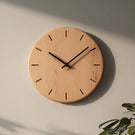 Minimal round wooden wall clock with linear hour marks