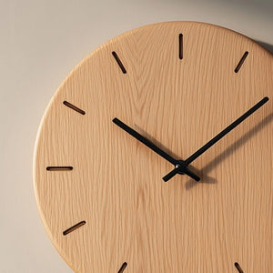 Minimal round wooden wall clock with linear hour marks angled view highlighting wood grain