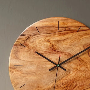 Organic grain round wooden wall clock angled view highlighting natural pattern