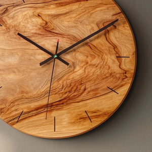 Organic grain round wooden wall clock close up showing wood grain and hands detail