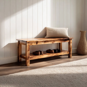 Rustic wooden entryway bench with lower storage shelf placed against wall in natural light