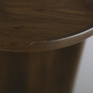 Scandinavian round wooden coffee table with thick legs close up edge detail