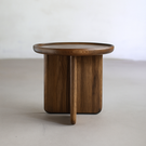 Scandinavian round wooden coffee table with thick legs side view showing leg design