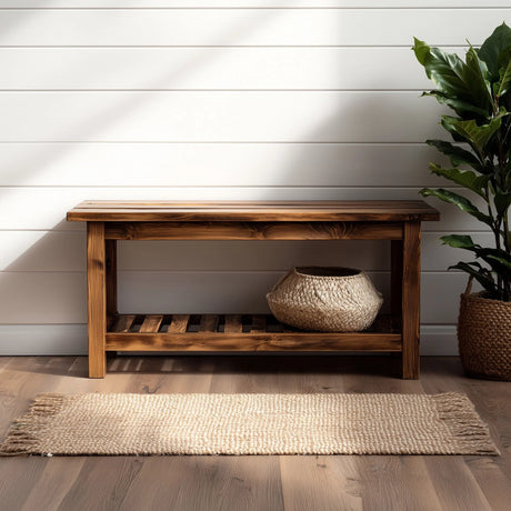 Simple wooden entryway bench with lower storage shelf placed against wall with plant decor