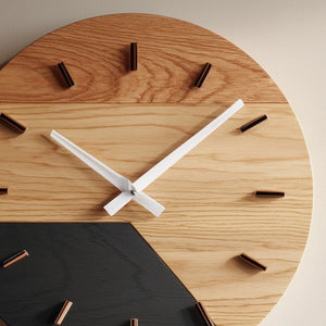 Two tone circular wooden wall clock close up showing dial hands and wood detail
