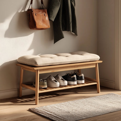 Minimal wooden entryway bench with lower shoe shelf placed near wall with hanging items